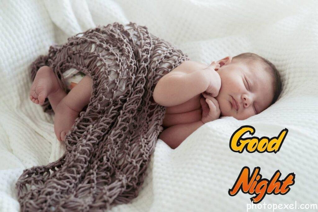 Baby-Boy-Lying-On-A-White-Bed-Good-Night-Images