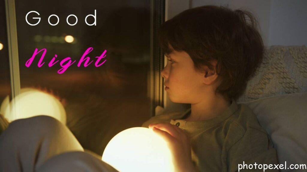 Boy-Holding-A-Glowing-Lamp-Looking-Through-A-Window-At-Night-Good-Night-Images