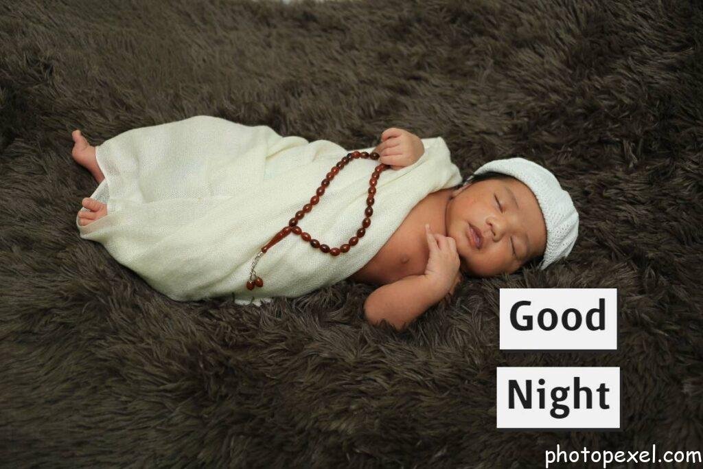 Infant-Sleeping-In-White-Cloth-And-Cap-Holding-Prayer-Beads-Good-Night-Images