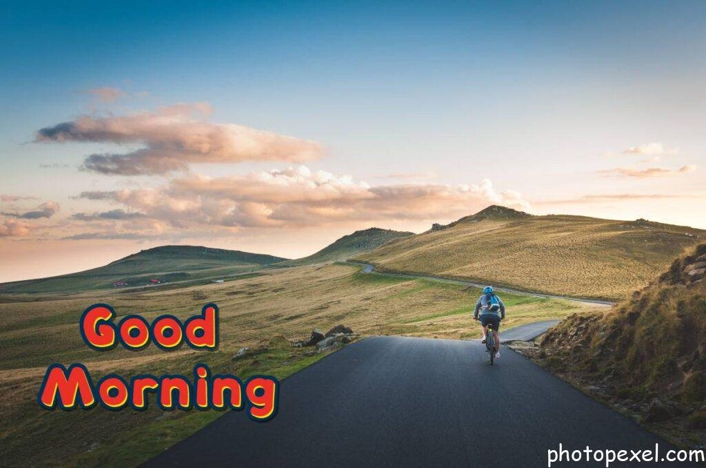 Solitary-Man-Cycling-Bicycle-Roads-Paths-Street-Land-Plains-Dirt-Grass-Mountains-Summits-Sky-Good-Morning-Images