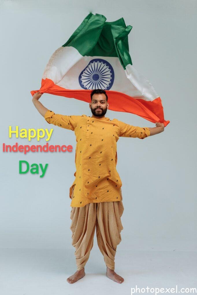 A-Bearded-Man-In-Traditional-Outfit-Holding-An-Indian-Flag-Happy-Independence-Day-Images